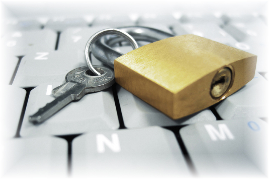 Image: Key and security lock lying on a computer keyboard Image: Key and security lock lying on a computer keyboard